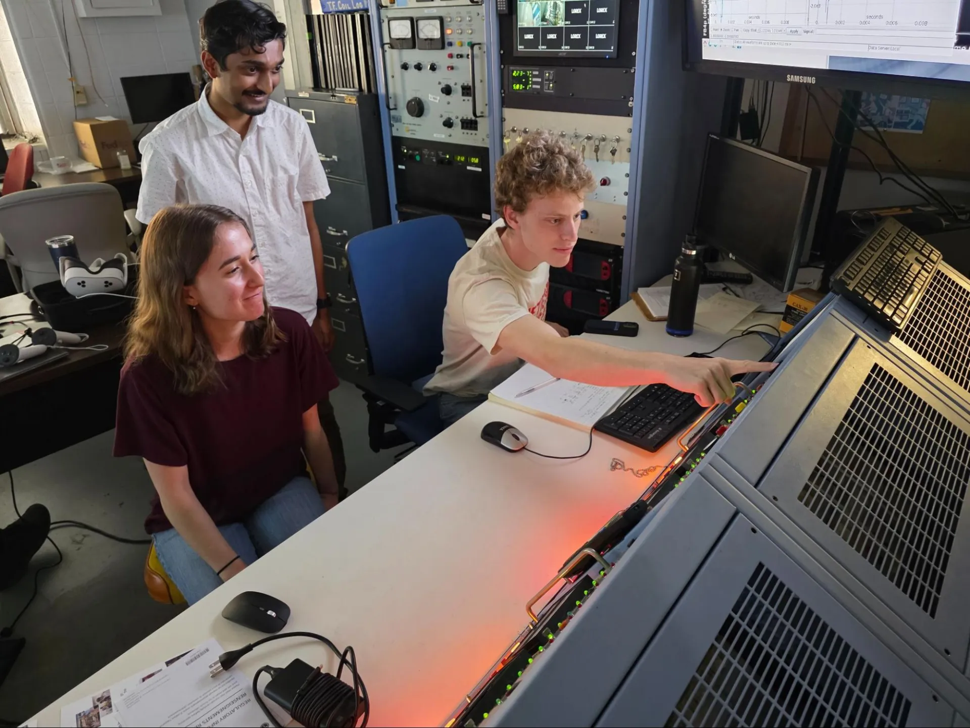 Sam Prausnitz-Weinbaum (Stanford University), Deniz Yilmaz (Stanford University), and Tanmay Gupta (Columbia) prepare a plasma pulse at the HBT-EP control panel.