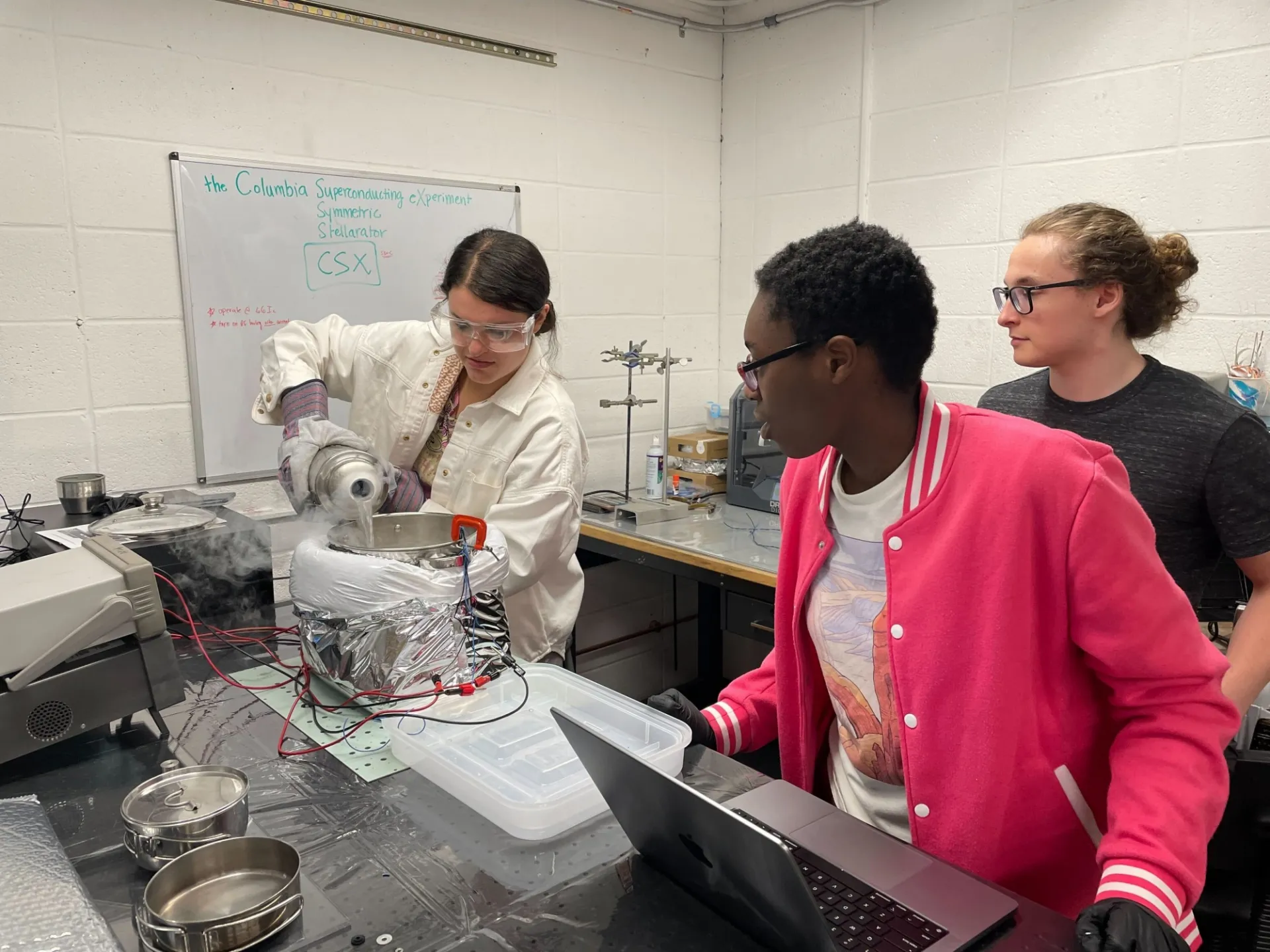 Students performing cryogenic testing of high temperature superconductor