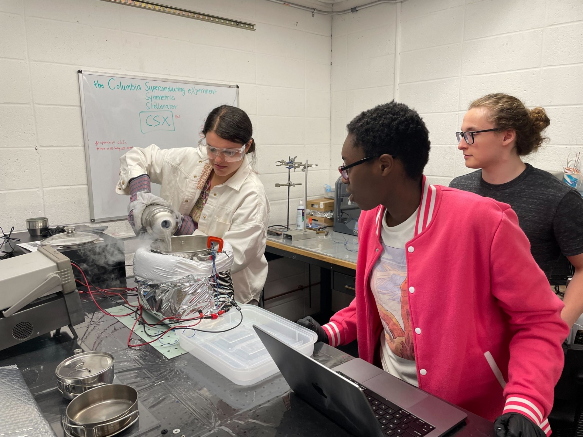 Students performing cryogenic testing of high temperature superconductor Students performing cryogenic testing of high temperature superconductor