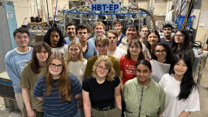 Most of the undergraduate cohort posing in front of the HBT-EP Tokamak
